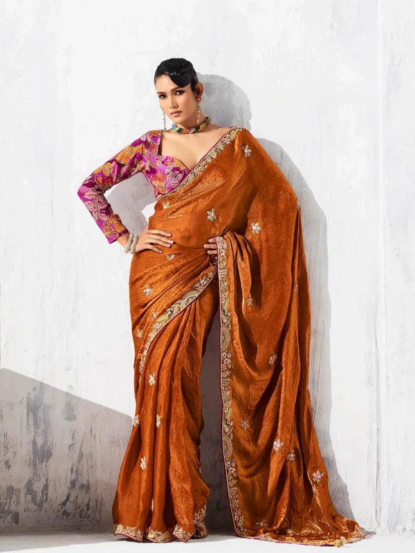 Rust orange tissue silk saree accented with resham work