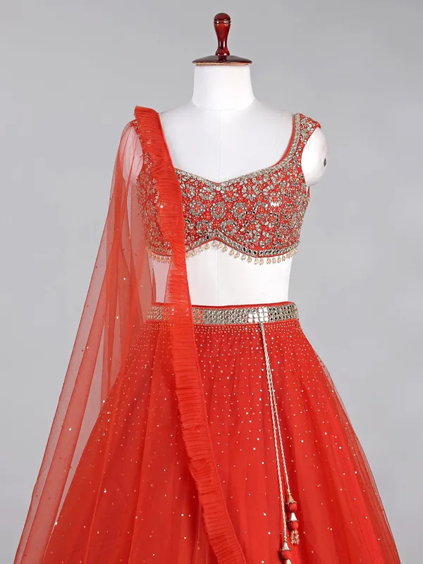 Rust red net lehenga choli with sparkling sequins