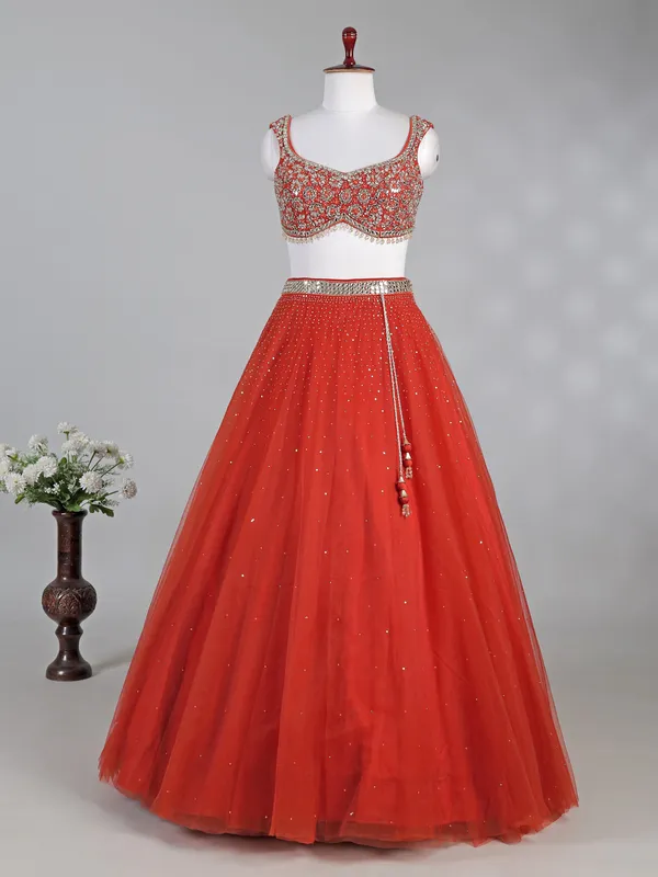 Rust red net lehenga choli with sparkling sequins