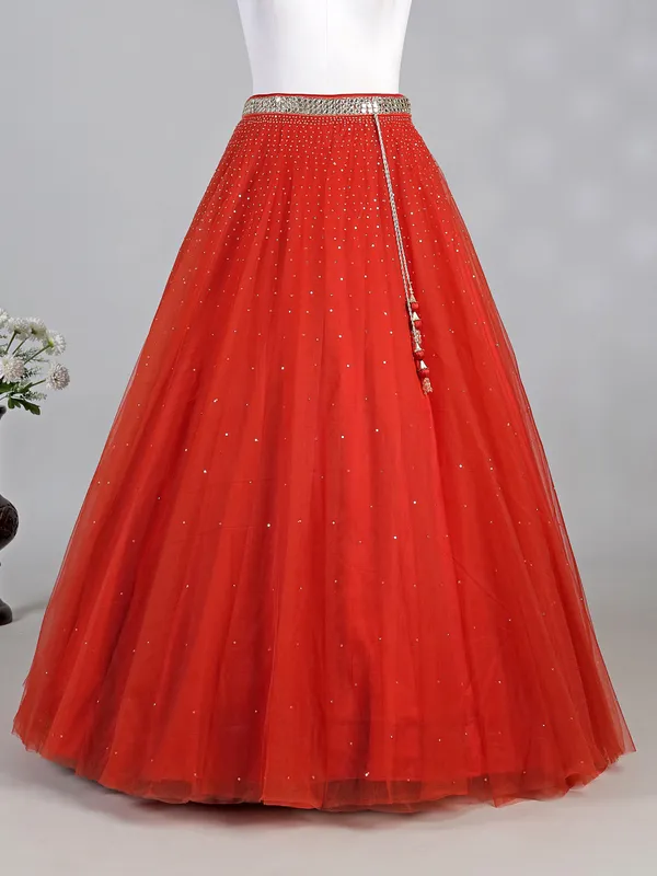 Rust red net lehenga choli with sparkling sequins