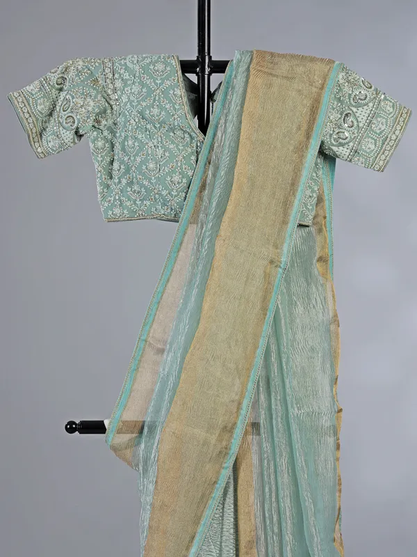 Sage green organza saree with zari weaving