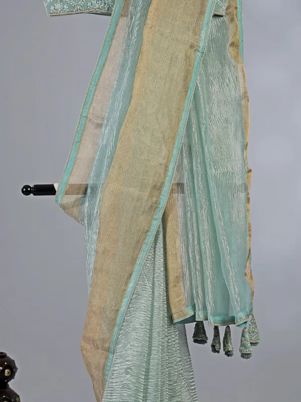 Sage green organza saree with zari weaving
