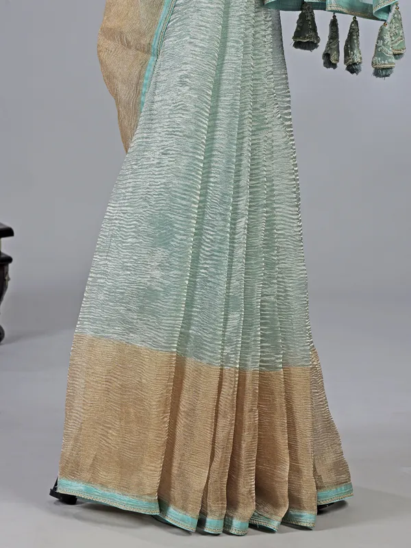 Sage green organza saree with zari weaving