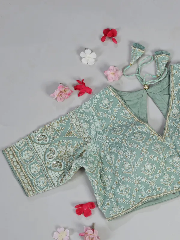 Sage green organza saree with zari weaving