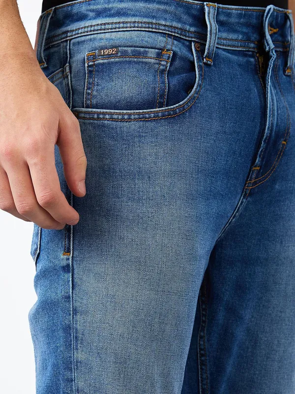 SPYKAR washed mid blue slim fit denim for men