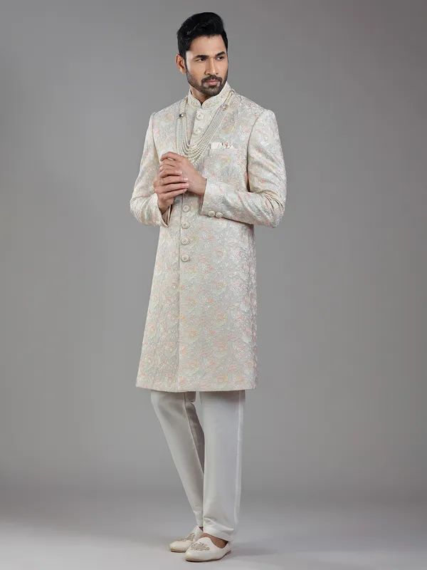 Timeless craftsmanship in grey raw silk with multi-colored embroidery