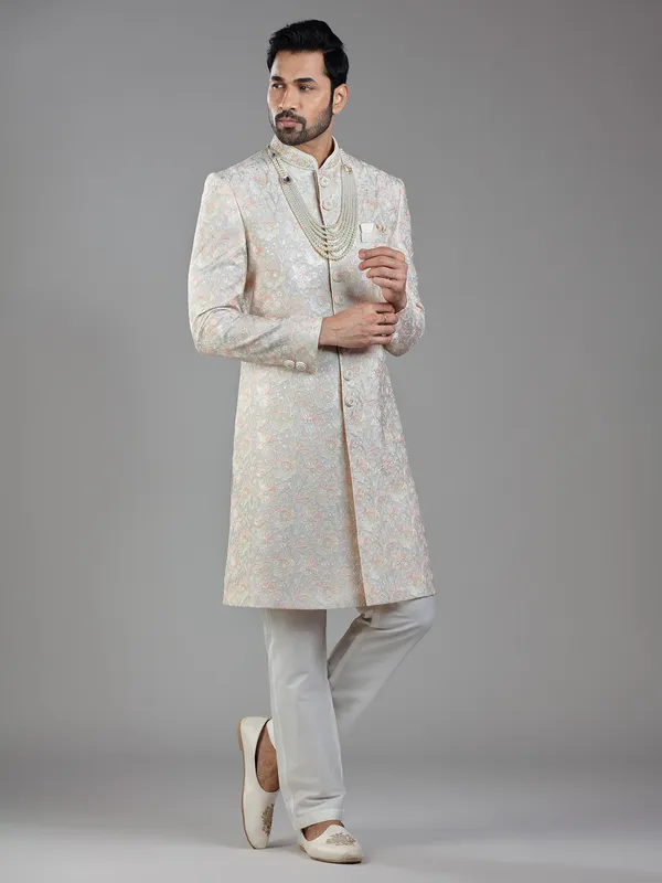 Timeless craftsmanship in grey raw silk with multi-colored embroidery