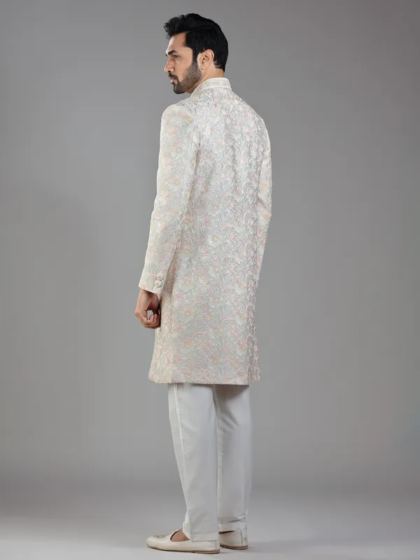 Timeless craftsmanship in grey raw silk with multi-colored embroidery