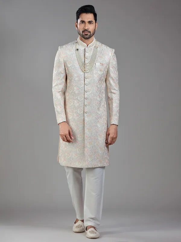 Timeless craftsmanship in grey raw silk with multi-colored embroidery