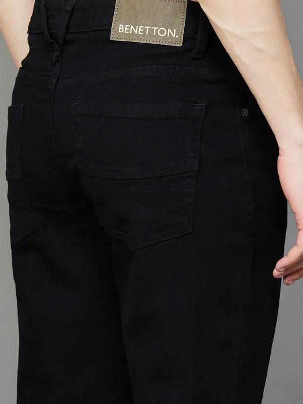 UCB solid black slim tapered fit denim jeans for men