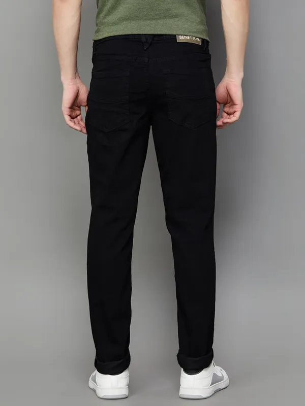 UCB solid black slim tapered fit denim jeans for men