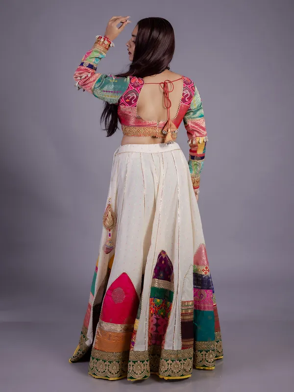 White silk lehenga choli with cowrie shell work
