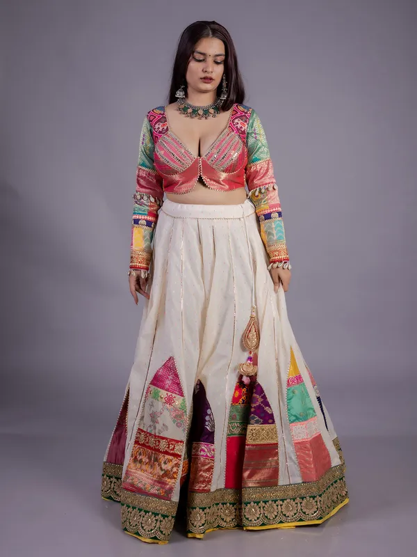 White silk lehenga choli with cowrie shell work