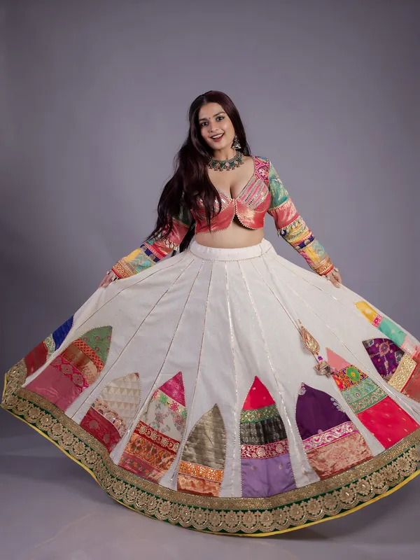White silk lehenga choli with cowrie shell work