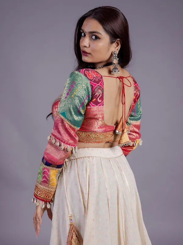 White silk lehenga choli with cowrie shell work