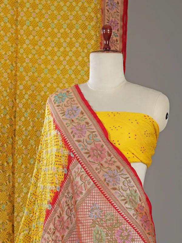 Yellow bandhej silk saree with unstitched blouse