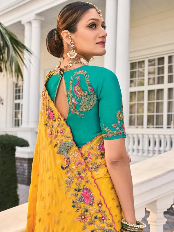 Yellow crape saree with rich festive appeal