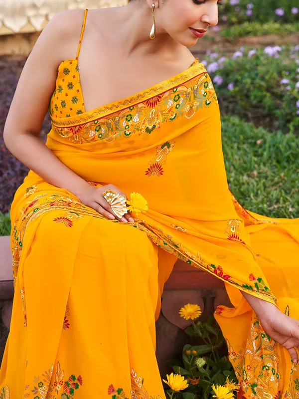 Yellow georgette saree with printed stone detail