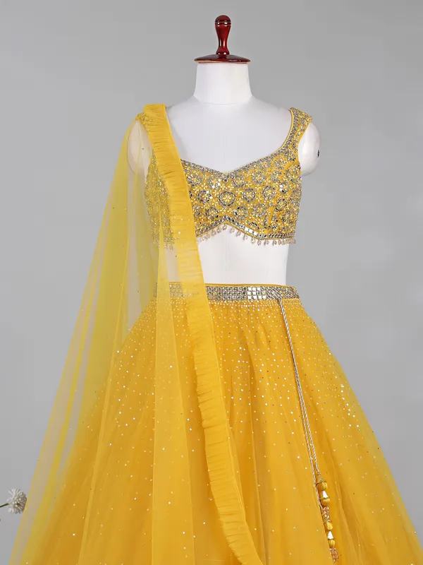 Yellow net lehenga choli with aabla and diamond work