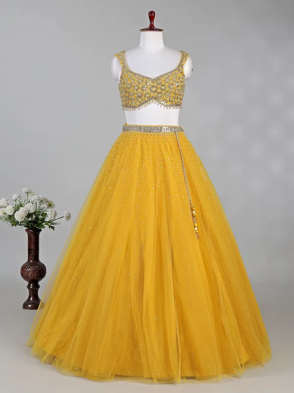 Yellow net lehenga choli with aabla and diamond work