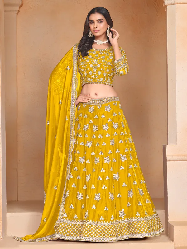 Yellow organza lehenga choli with zari and sequin highlights