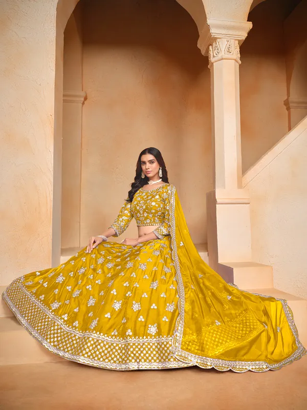 Yellow organza lehenga choli with zari and sequin highlights