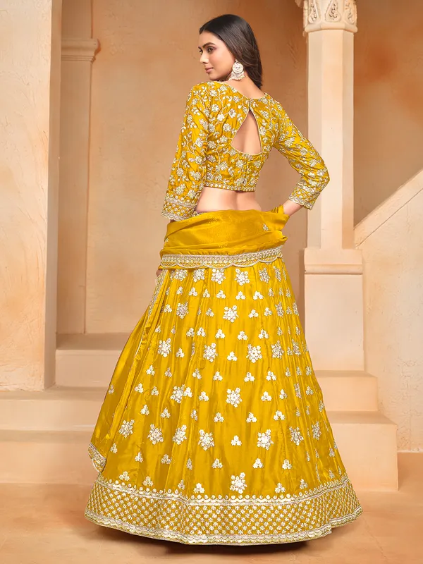 Yellow organza lehenga choli with zari and sequin highlights