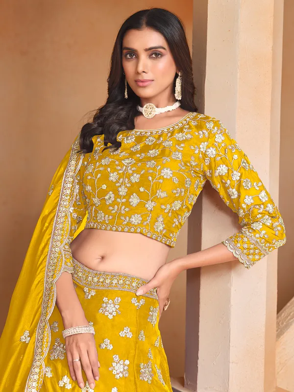 Yellow organza lehenga choli with zari and sequin highlights