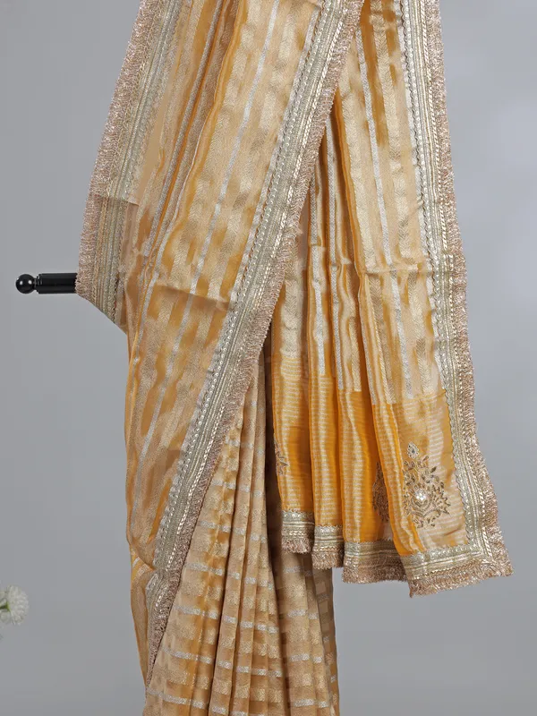 Yellow organza saree with mirror work
