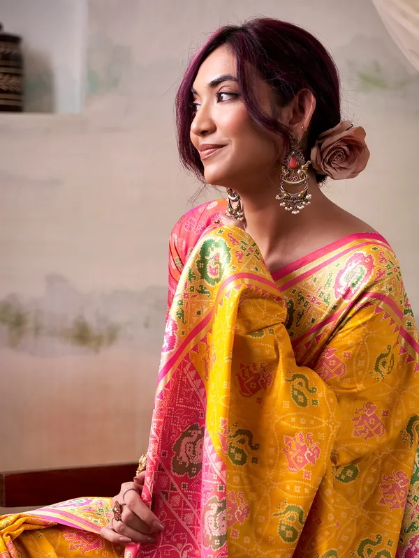 Yellow patola silk saree with pink blouse
