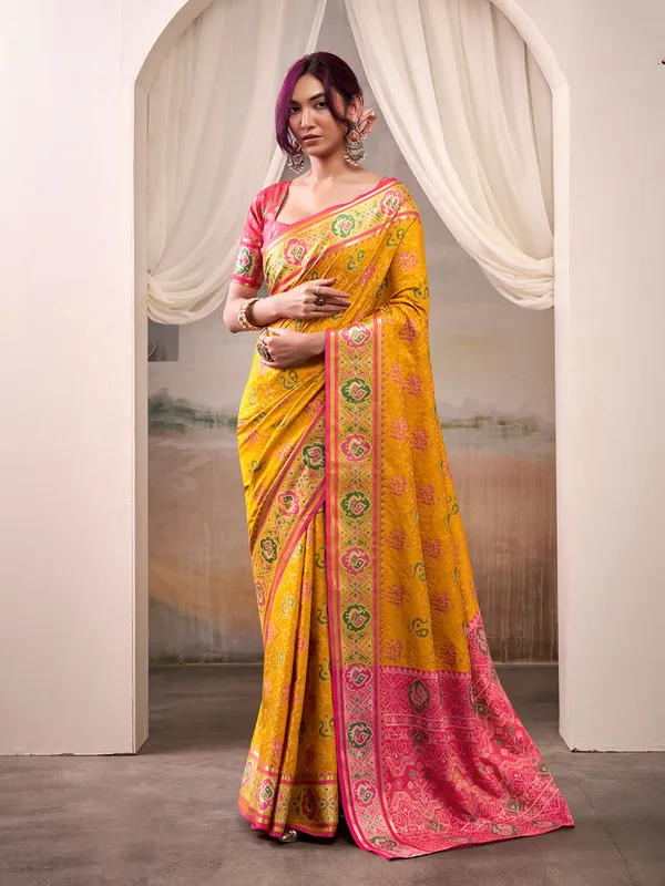 Yellow patola silk saree with pink blouse