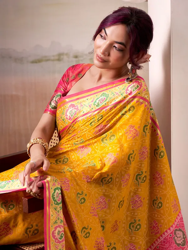 Yellow patola silk saree with pink blouse