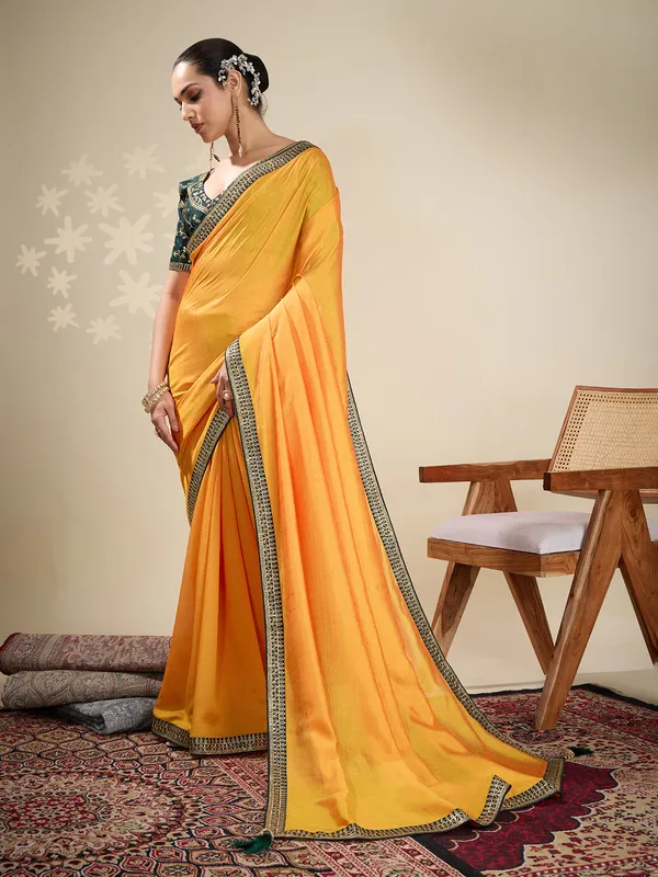 Yellow plain silk saree with green blouse