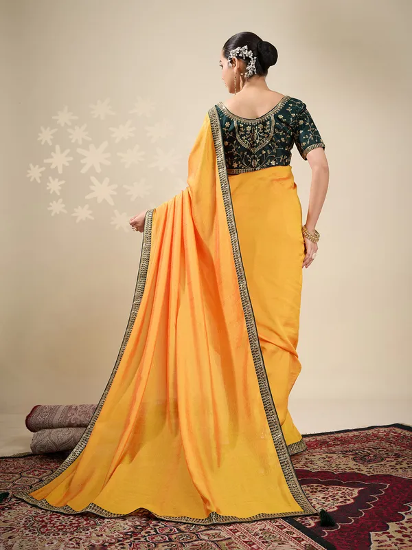 Yellow plain silk saree with green blouse