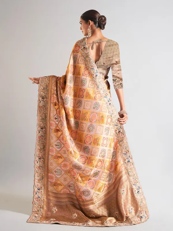 Yellow silk printed saree with embellished border