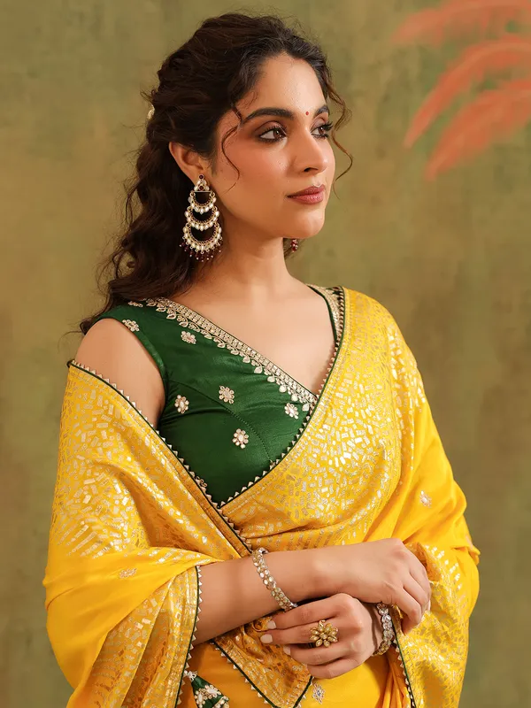 Yellow silk saree with green blouse