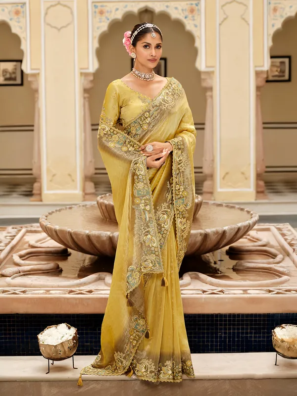 Yellow silk saree with rich embellished border