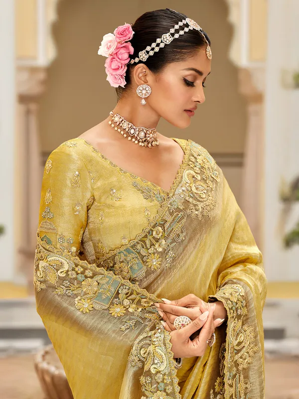 Yellow silk saree with rich embellished border