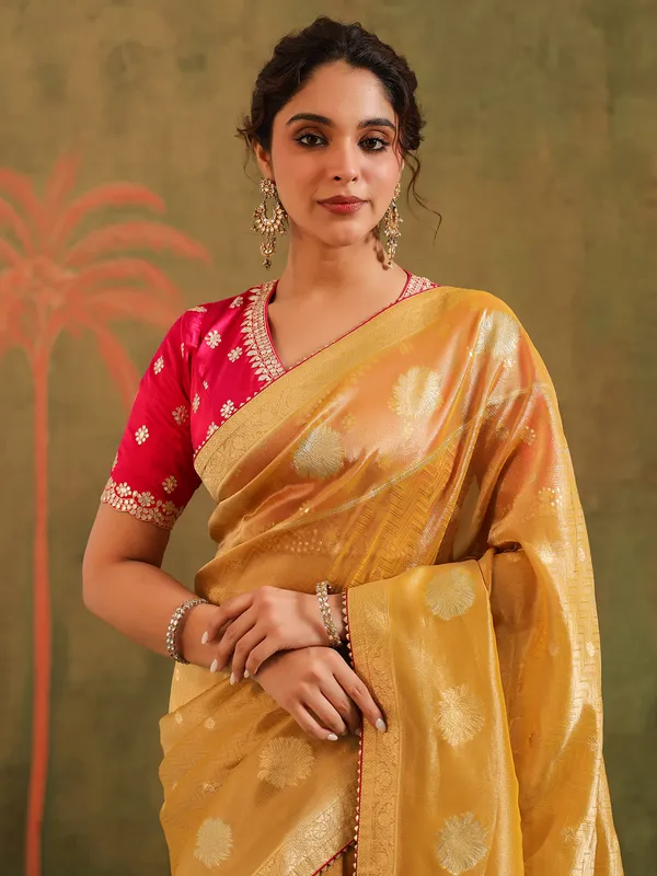 Yellow silk zari embellished saree with magenta blouse