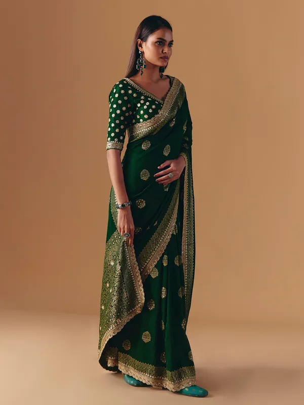 Dark green silk saree with heavy work blouse