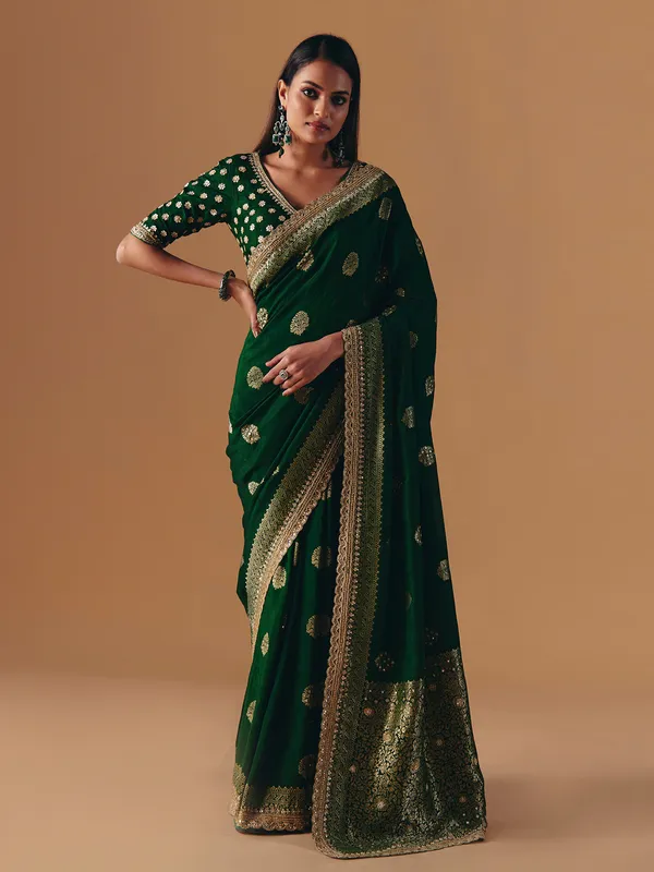 Dark green silk saree with heavy work blouse