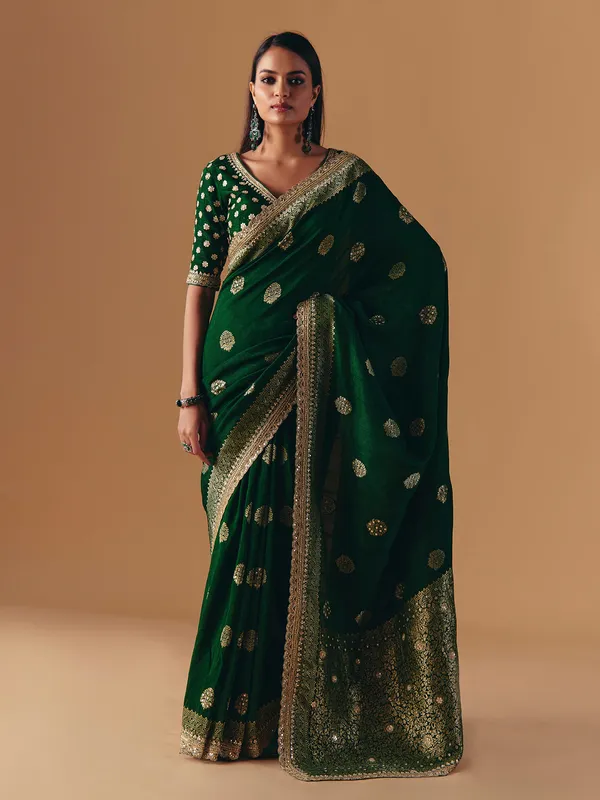 Dark green silk saree with heavy work blouse