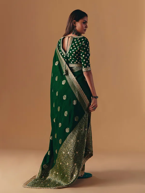 Dark green silk saree with heavy work blouse