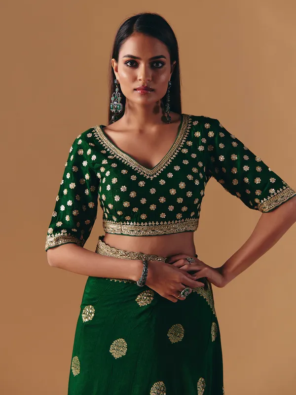 Dark green silk saree with heavy work blouse