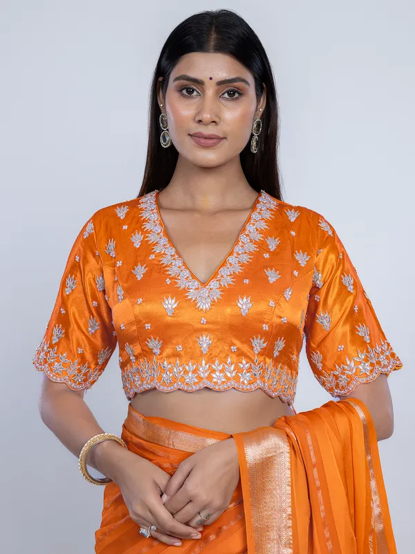 Orange organza satin saree with stone studded blouse