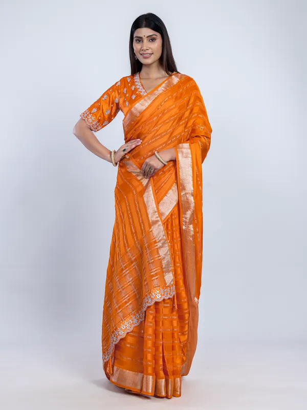 Orange organza satin saree with stone studded blouse