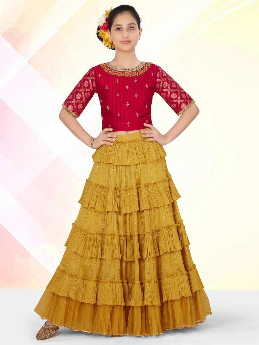 A mustard yellow georgette lehenga choli for little girls