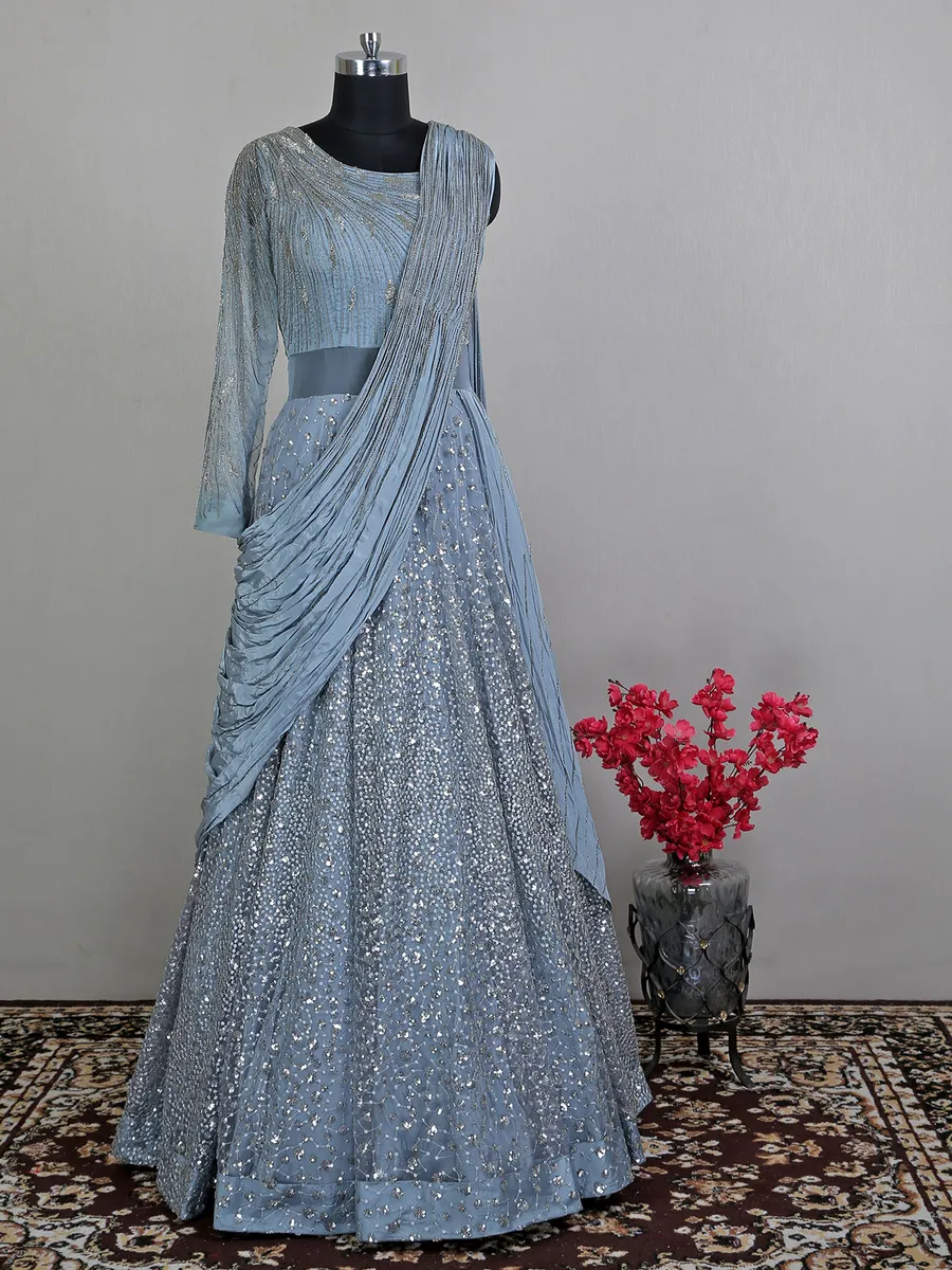 Blue net floor length gown with draped odhani pattern