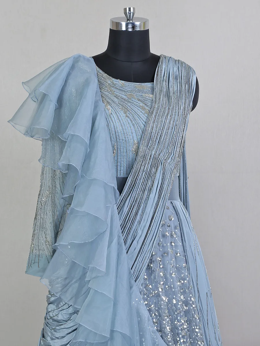 Blue net floor length gown with draped odhani pattern