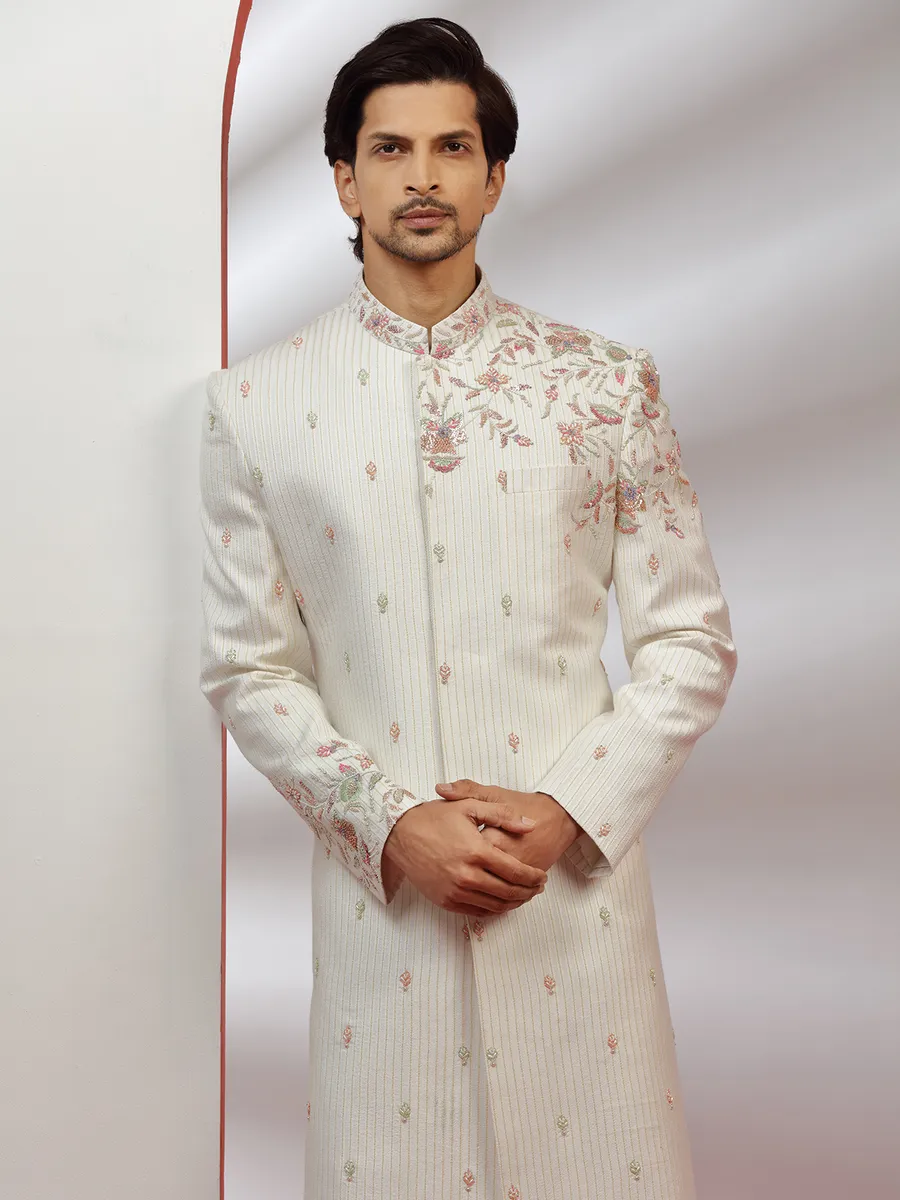 Cream hue raw silk groom wear sherwani